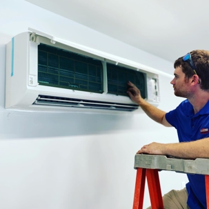 Man fixing air conditioner