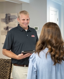 A water testing specialist speaking with a homeowner.