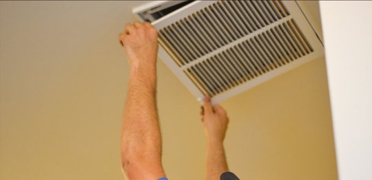 man adjusting vent