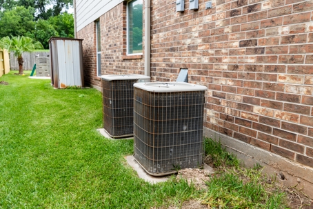 Older air conditioner units sitting next to home