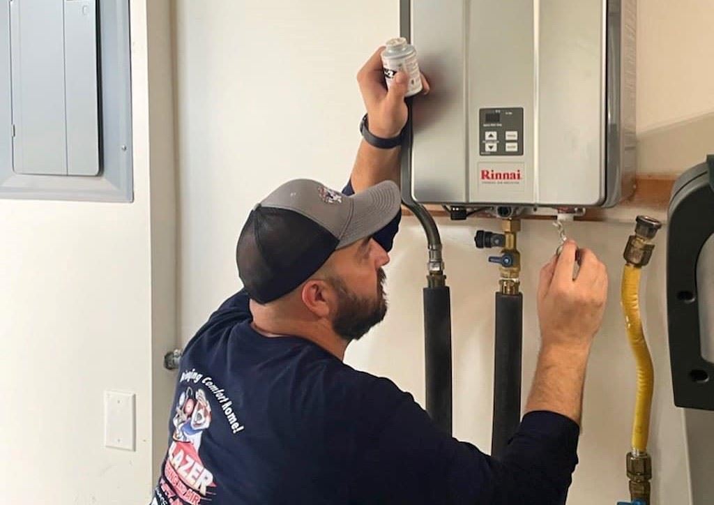 A man repairing a tankless water heater.